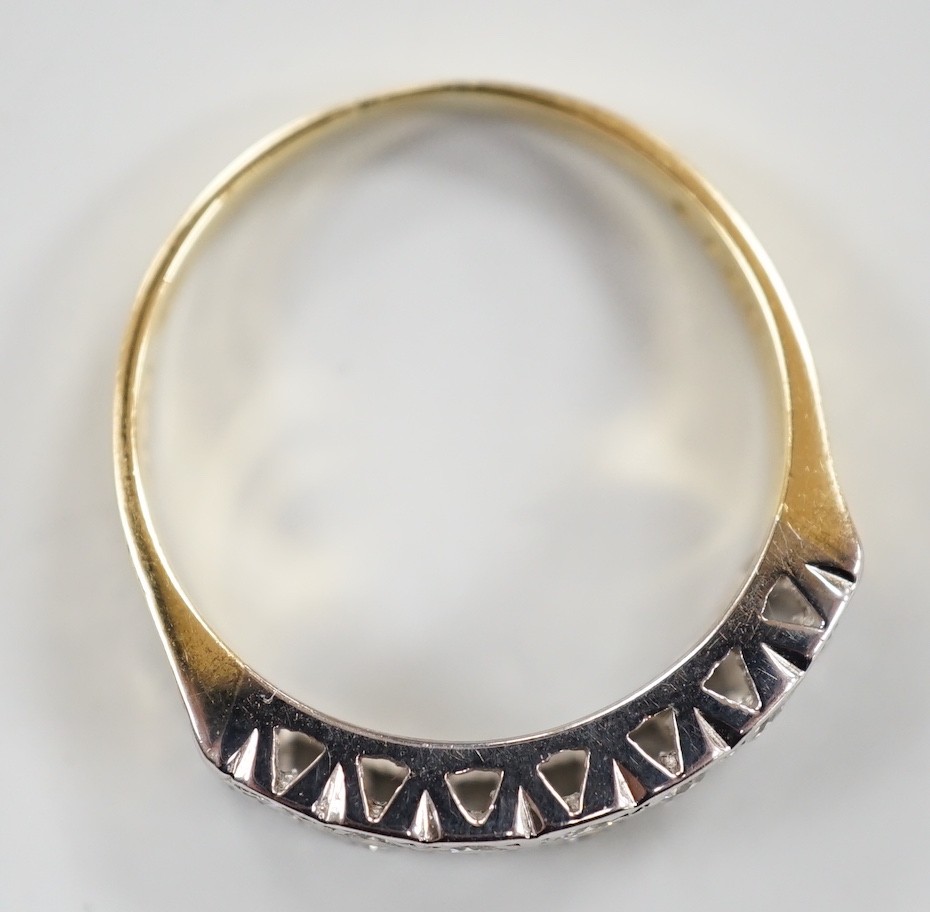 A modern 18ct gold and fourteen stone two row diamond set half hoop ring, size R/S, with textured shoulders, gross weight 5.4 grams.